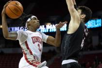 UNLV Rebels forward Donovan Williams (3) drives past Omaha Mavericks center Dylan Brougham (14) ...