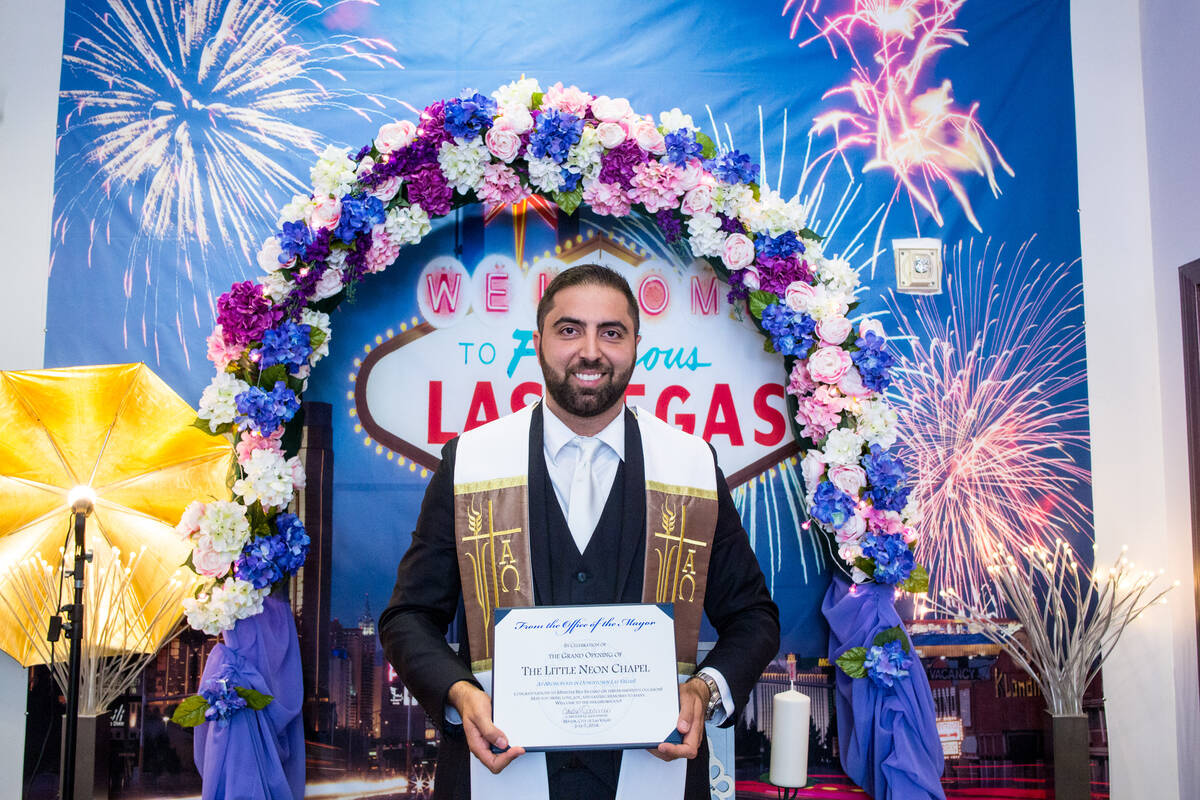 Minister and Little Neon Chapel owner Ben Silvano, holds a certificate presented by the Mayor C ...
