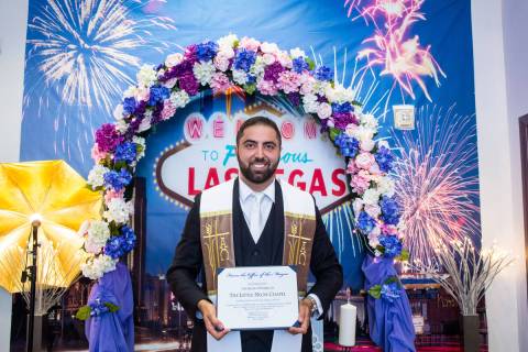 Little Neon Chapel owner Ben Silvano holds a certificate during the chapel's grand opening at N ...