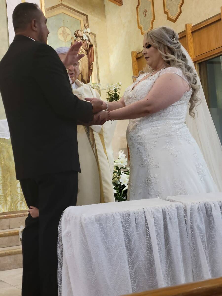 A North Las Vegas priest officiates the wedding of Mayra Ramos and Oscar Zuniga on April 23. (C ...