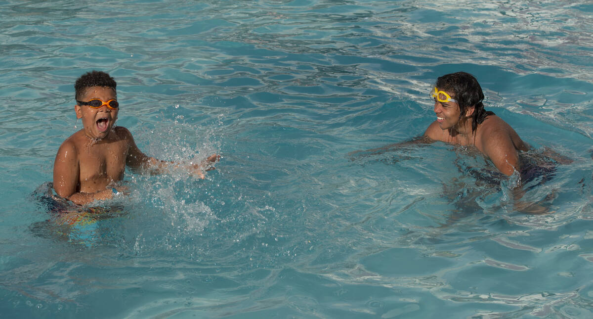 Sanon Nwaubani, 7, left, and his brother Boaz Rice, 15, of Indiana swim in the newly-opened Cir ...