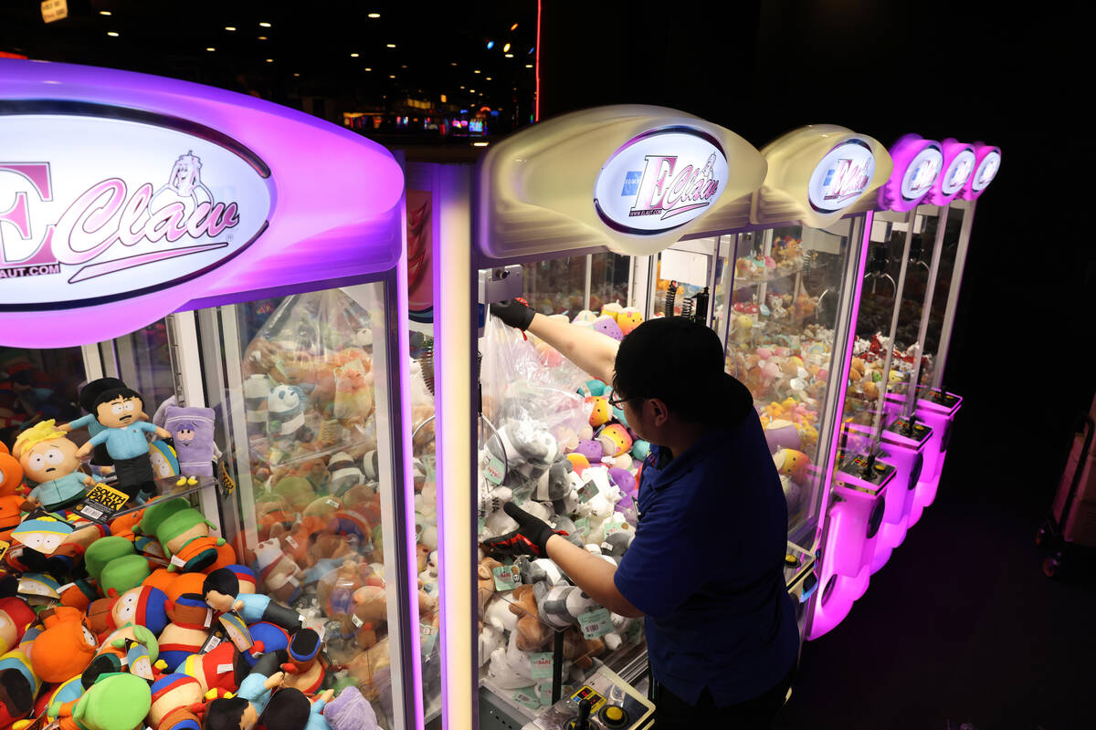 A worker refills prizes at a new midway at Circus Circus on the Strip in Las Vegas Friday, June ...