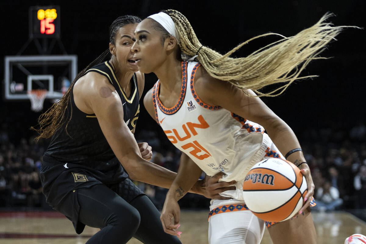 Connecticut Sun guard DiJonai Carrington (21) drives around Las Vegas Aces center Kiah Stokes ( ...