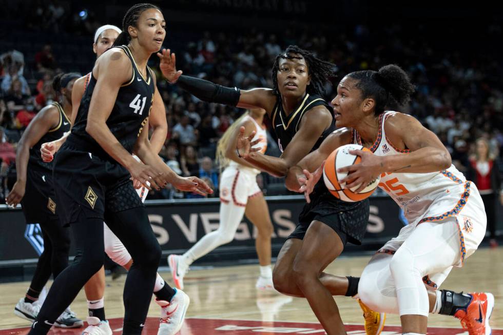 Connecticut Sun forward Alyssa Thomas (25) drives around Las Vegas Aces guard Aisha Sheppard (4 ...