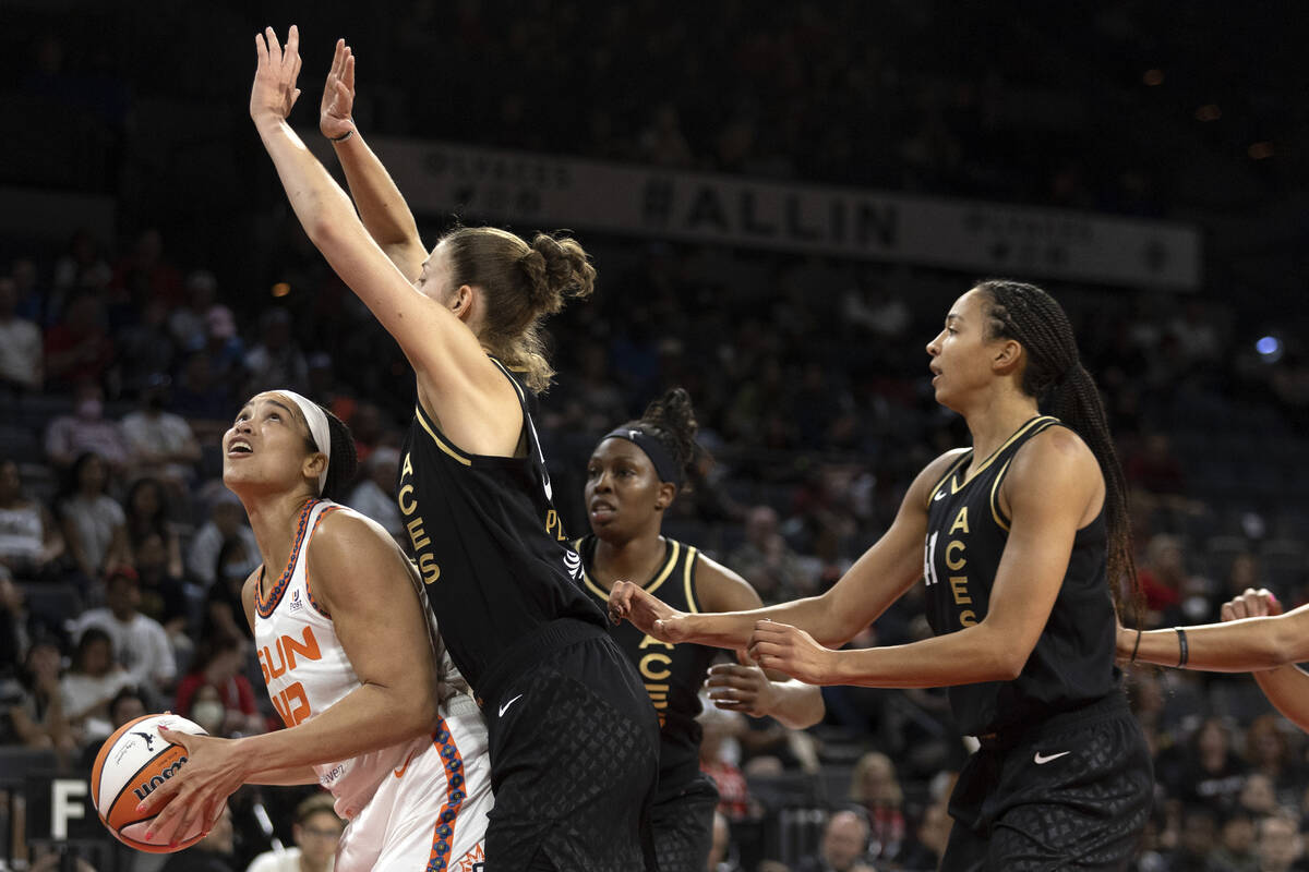 Connecticut Sun center Brionna Jones (42) looks to shoot while Las Vegas Aces forward Theresa P ...