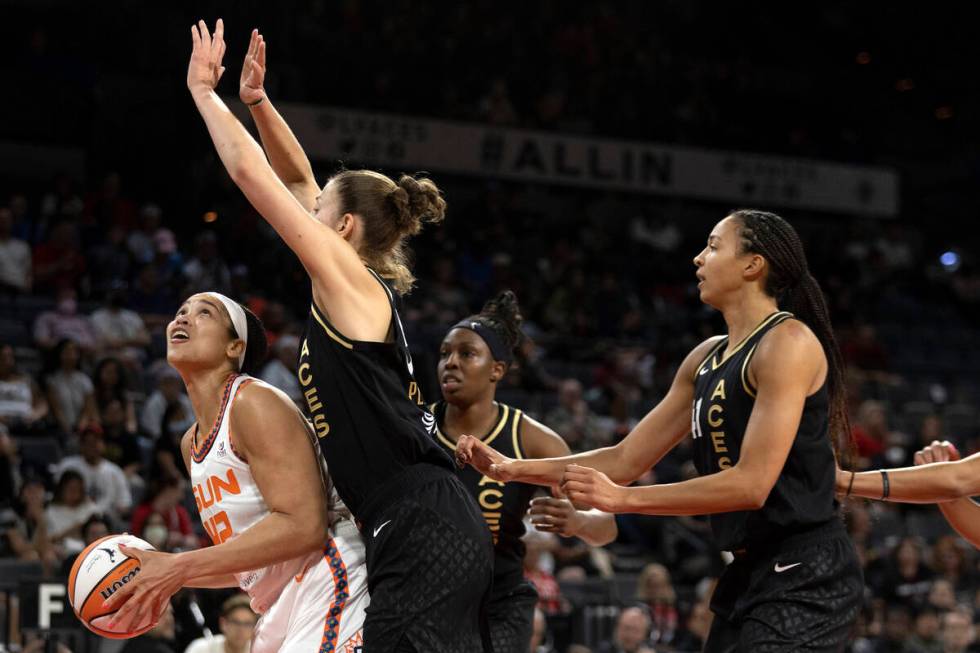 Connecticut Sun center Brionna Jones (42) looks to shoot while Las Vegas Aces forward Theresa P ...