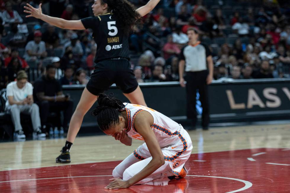 Connecticut Sun forward DeWanna Bonner (24) falls to the ground after Las Vegas Aces forward De ...