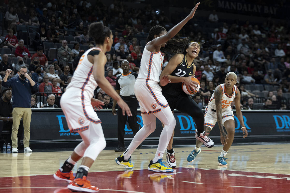 Las Vegas Aces forward A'ja Wilson (22) drives around Connecticut Sun forward Jonquel Jones (35 ...