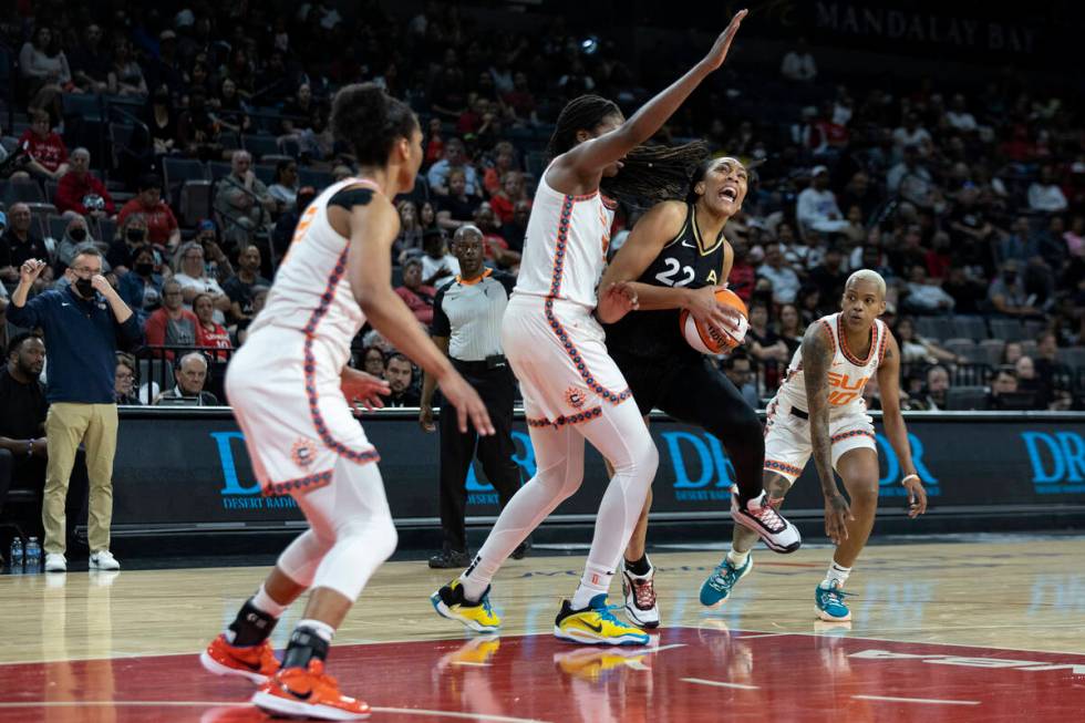 Las Vegas Aces forward A'ja Wilson (22) drives around Connecticut Sun forward Jonquel Jones (35 ...