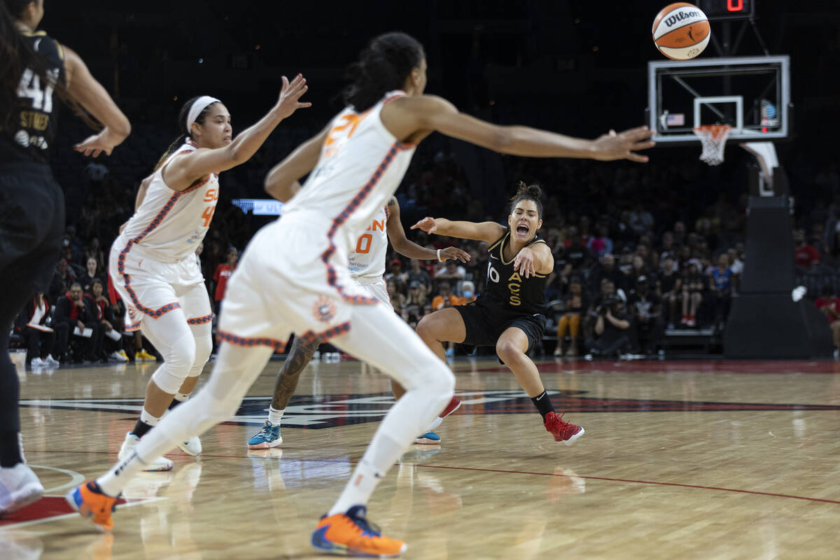 Las Vegas Aces guard Kelsey Plum (10) falls while passing as Connecticut Sun center Brionna Jon ...