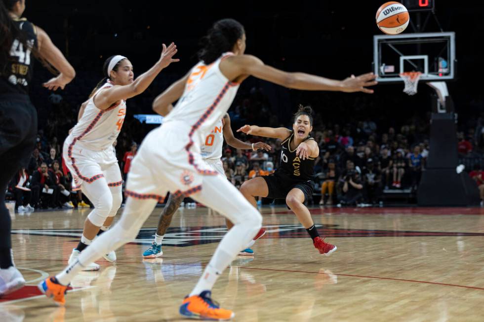 Las Vegas Aces guard Kelsey Plum (10) falls while passing as Connecticut Sun center Brionna Jon ...