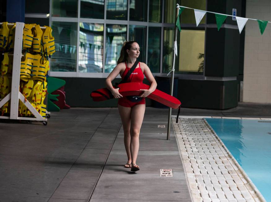 Morgan Mollenkopf, a lifeguard, keeps an eye on swimmers as she walks around Pavilion Center Po ...