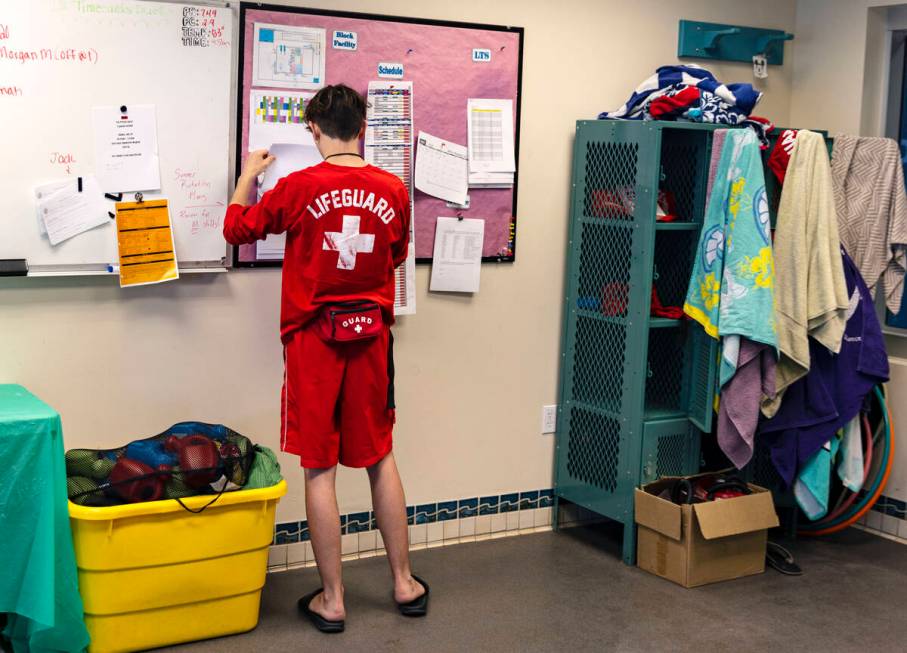 Aiden Ruggiutz, 18, a lifeguard, checks his schedule inside lifeguard shack at Pavilion Center ...