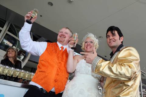 Jeremy Cardon, from left, and his bride Angel Dodson, of Colorado Springs, raise champagne glas ...