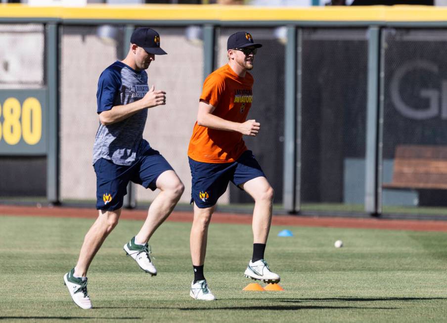 Aviator's pitchers Adam Kolarek, left, and Jared Koenig, warm up during team's practice at Las ...