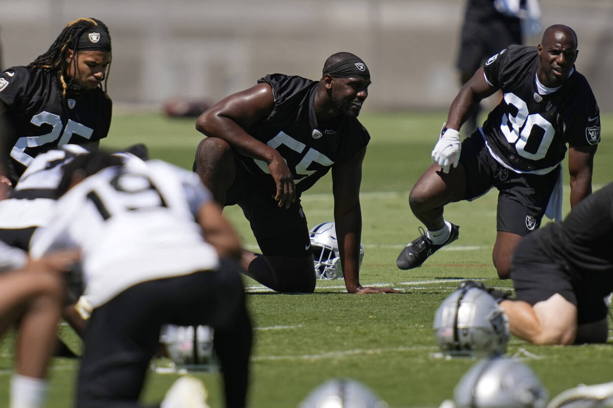 Las Vegas Raiders defensive end Chandler Jones, center, warms up during practice at the NFL foo ...