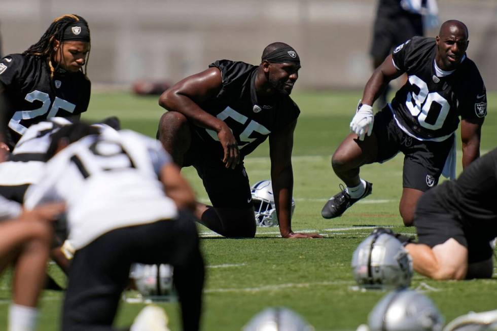Las Vegas Raiders defensive end Chandler Jones, center, warms up during practice at the NFL foo ...