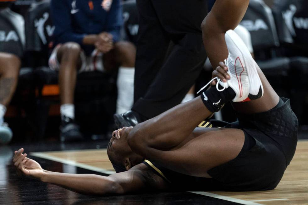 Las Vegas Aces guard Jackie Young (0) falls to the ground in pain during the second half of a W ...