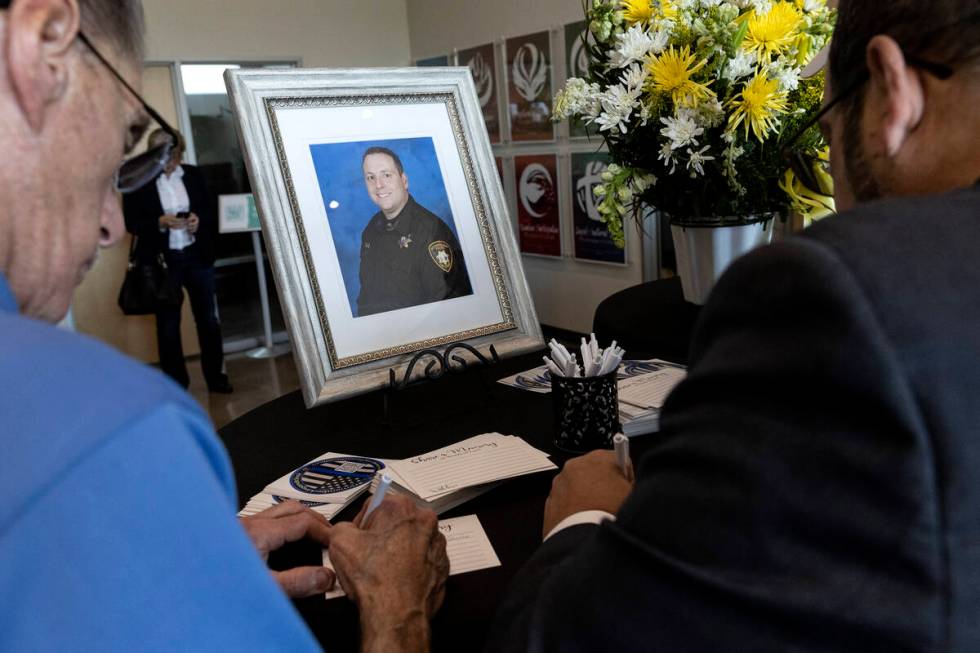 Mourners write their condolences during a funeral for Officer Phil Closi, a Metropolitan police ...