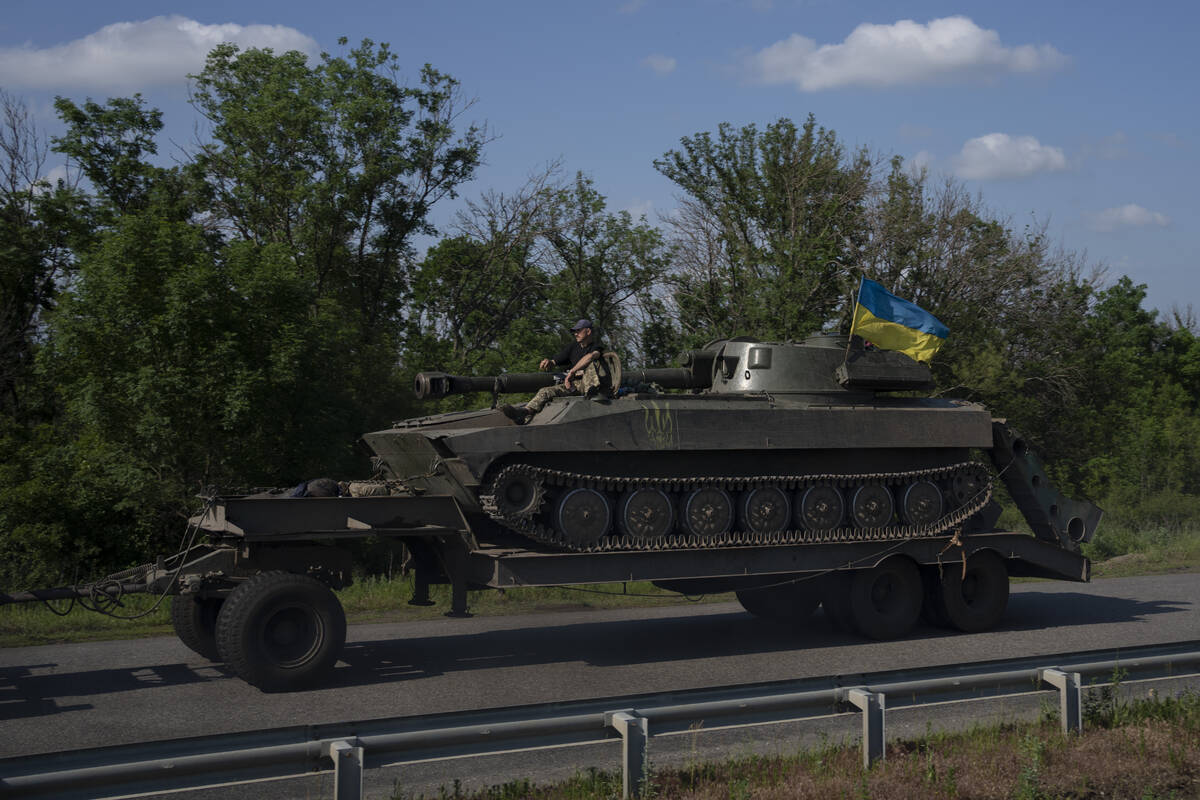 A tank is towed near Slovyansk, eastern Ukraine, Saturday, June 4, 2022. (AP Photo/Bernat Armangue)