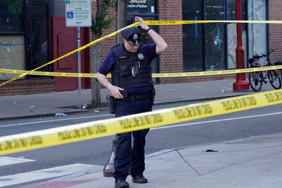 Philadelphia Police investigators work the scene of a fatal overnight shooting on South Street ...