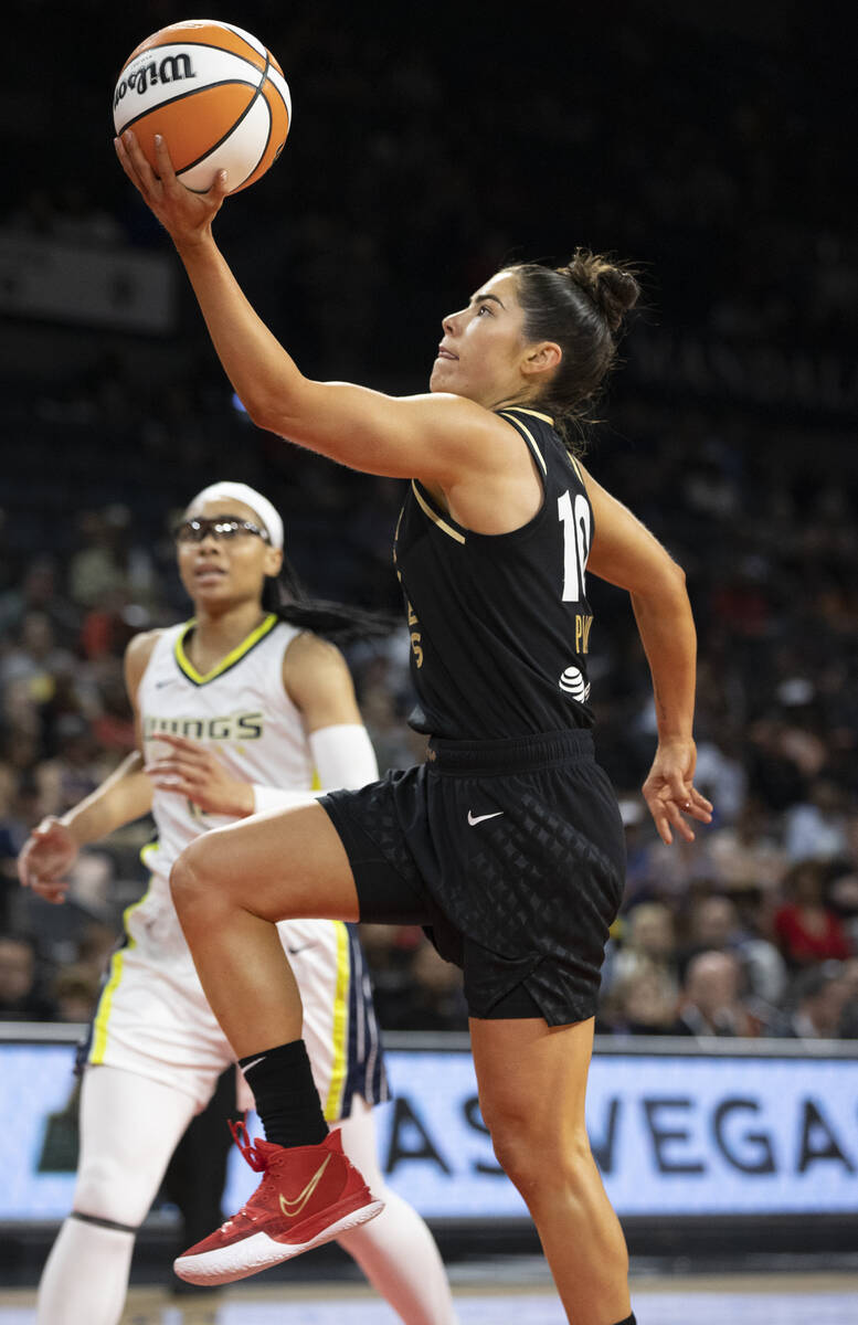 Aces guard Kelsey Plum (10) drives past Dallas Wings guard Allisha Gray (15) in the first half ...