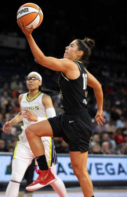 Aces guard Kelsey Plum (10) drives past Dallas Wings guard Allisha Gray (15) in the first half ...