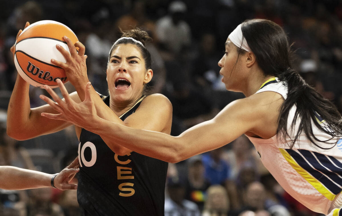 Aces guard Kelsey Plum (10) drives past Dallas Wings forward Isabelle Harrison (20) in the firs ...