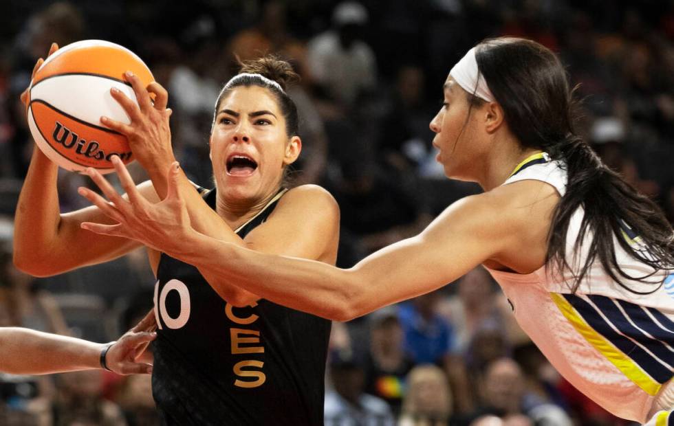 Aces guard Kelsey Plum (10) drives past Dallas Wings forward Isabelle Harrison (20) in the firs ...