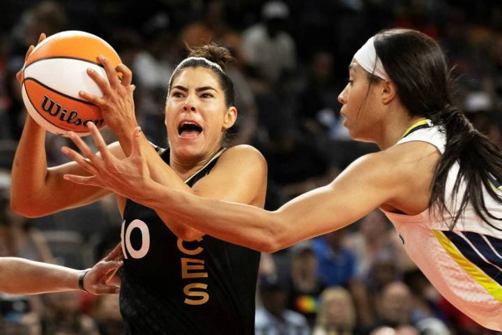 Aces guard Kelsey Plum (10) drives past Dallas Wings forward Isabelle Harrison (20) in the firs ...