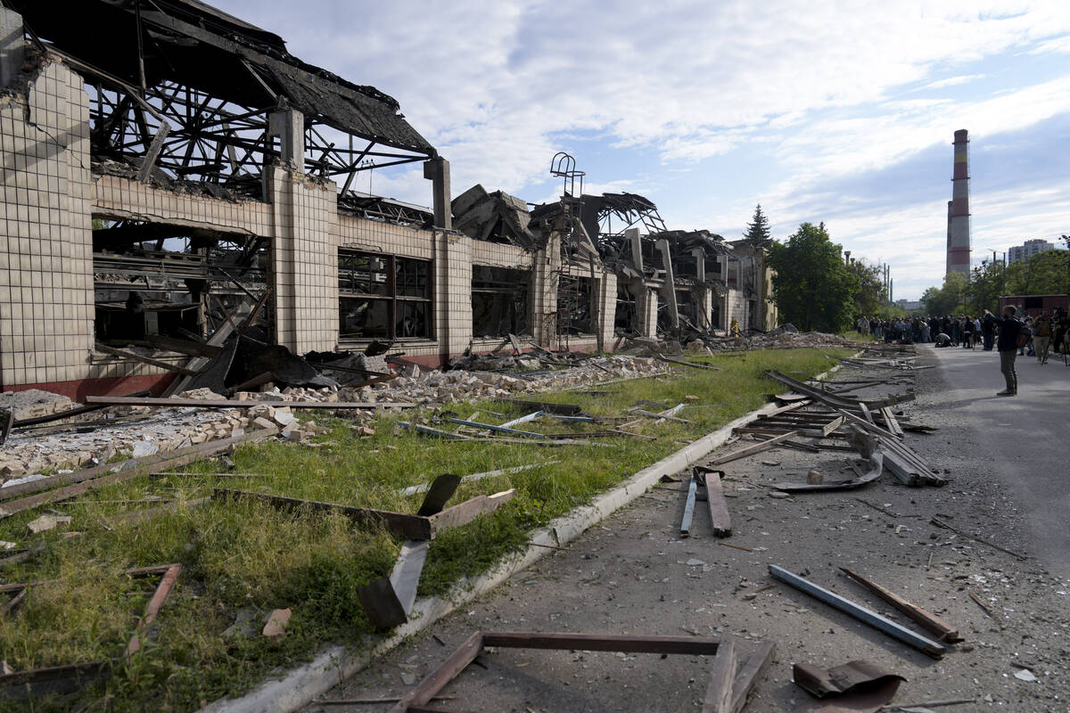 Wreckage lie along a street at a railway service facility hit by a Russian missile strike in Ky ...