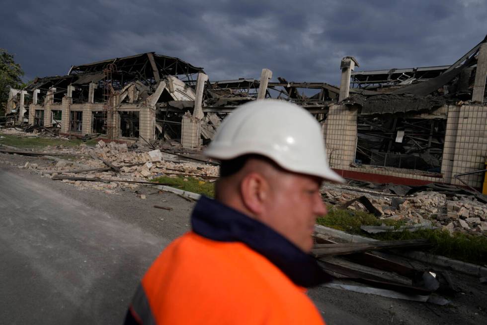 A worker looks at a railway service facility hit by a Russian missile strike in Kyiv, Ukraine, ...