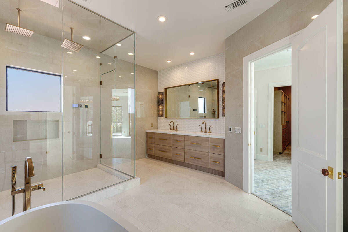 The master bath showcases a ThermaSol steam shower and heated marble flooring. (Ivan Sher Group)