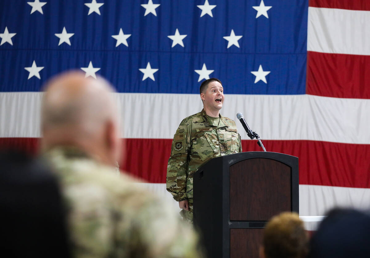 Technical Sgt. Kyle Carnegie sings the national anthem at an assumption of command ceremony at ...