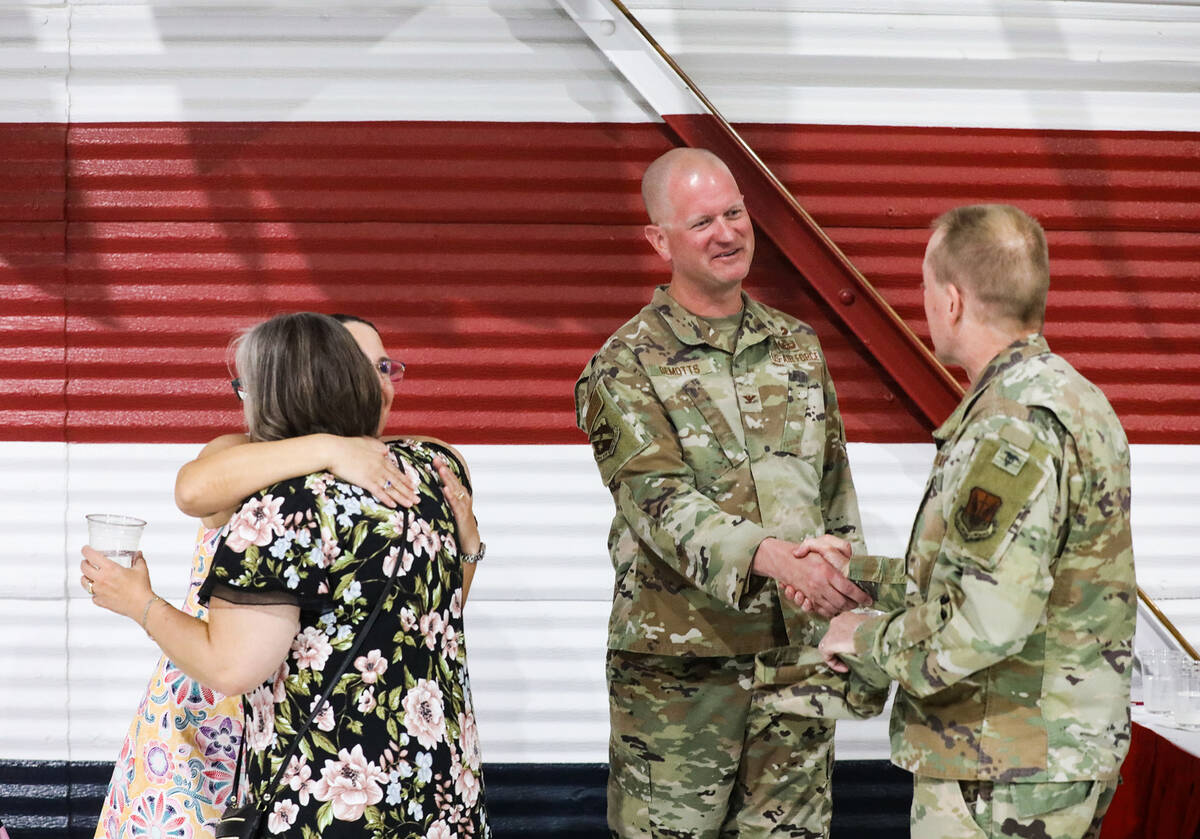 Col. Joshua DeMotts greets supporters alongside his wife Patty DeMotts after he took command of ...