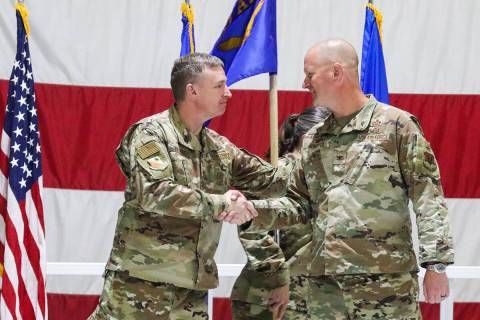 Brig. Gen. Evan Pettus, left, shakes hands with Col. Joshua DeMotts, right, as DeMotts assumes ...
