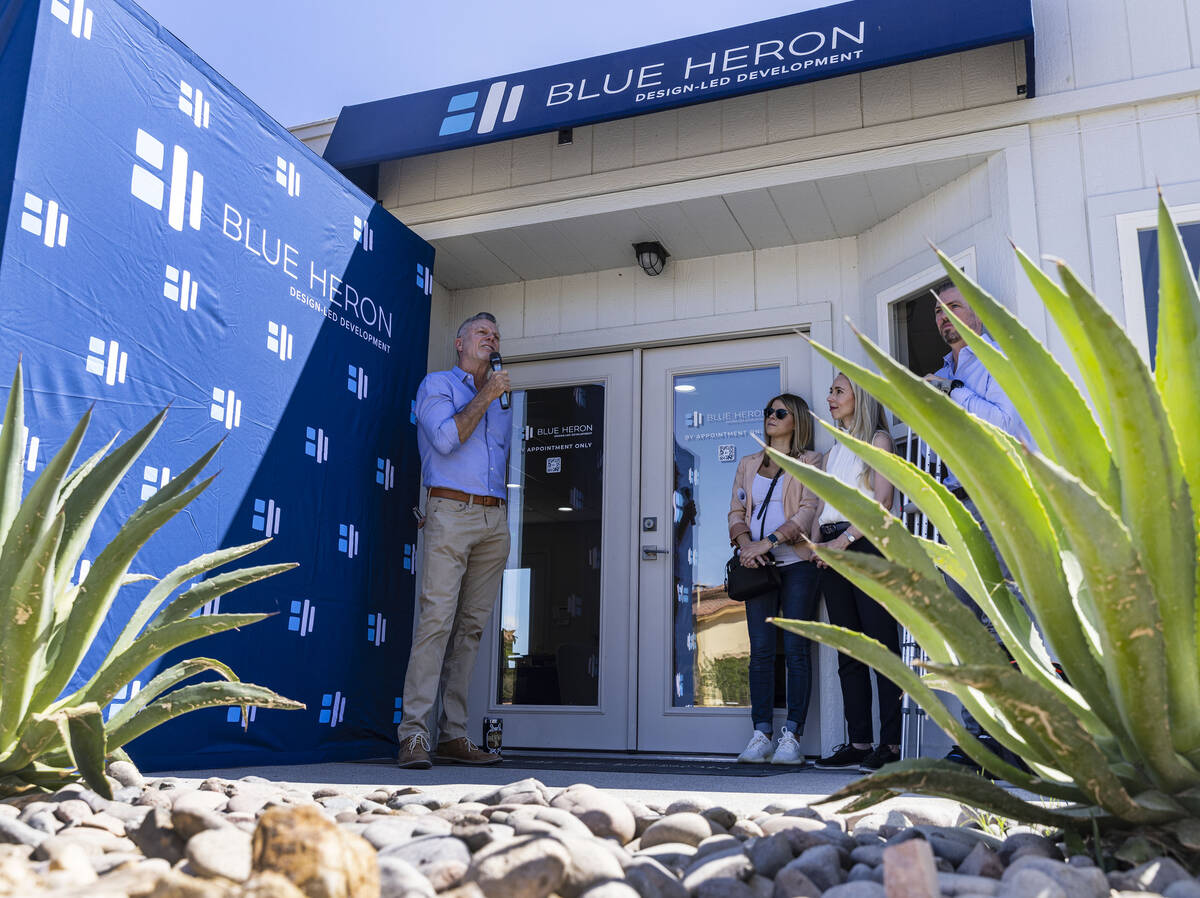 Chris Beucler, president of Blue Heron Nexus, speaks as Tyler Jones, CEO and founder of custom ...