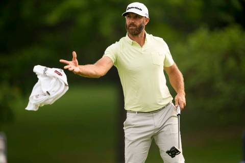 Dustin Johnson tosses his towel to his caddie on the 10th hole during the second round of the P ...