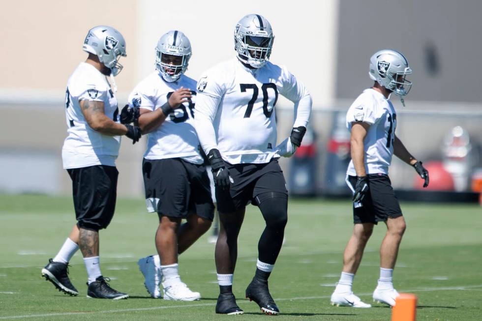 Raiders offensive lineman Alex Leatherwood (70) walks to a drill during the team’s manda ...