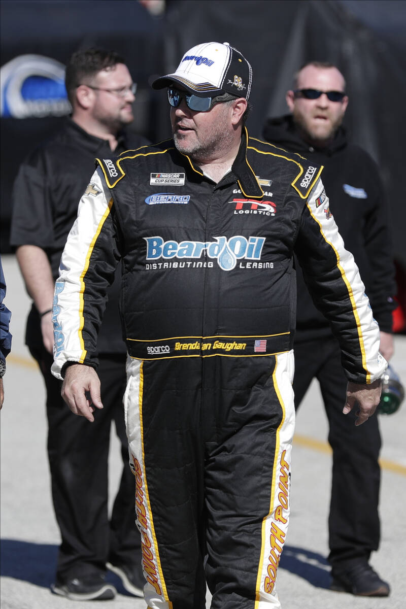 Brendan Gaughan walks to his car during NASCAR auto race practice at Daytona International Spee ...