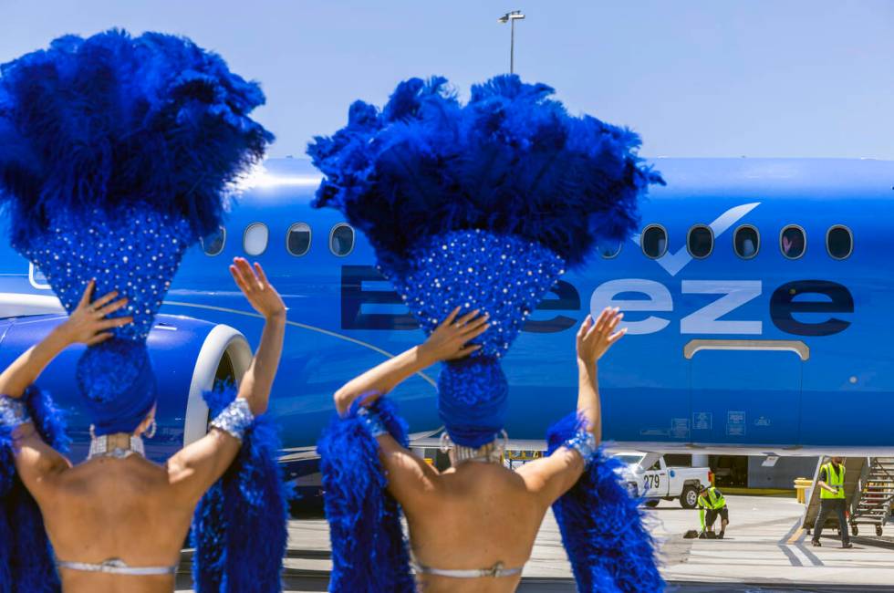 Showgirls Brooke, left, and Tara welcome passengers for the Breeze Airways inaugural flight arr ...