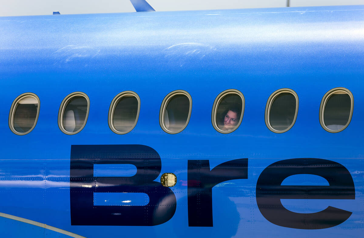 A Breeze Airways passenger looks out the window as their inaugural flight arrival makes it to t ...