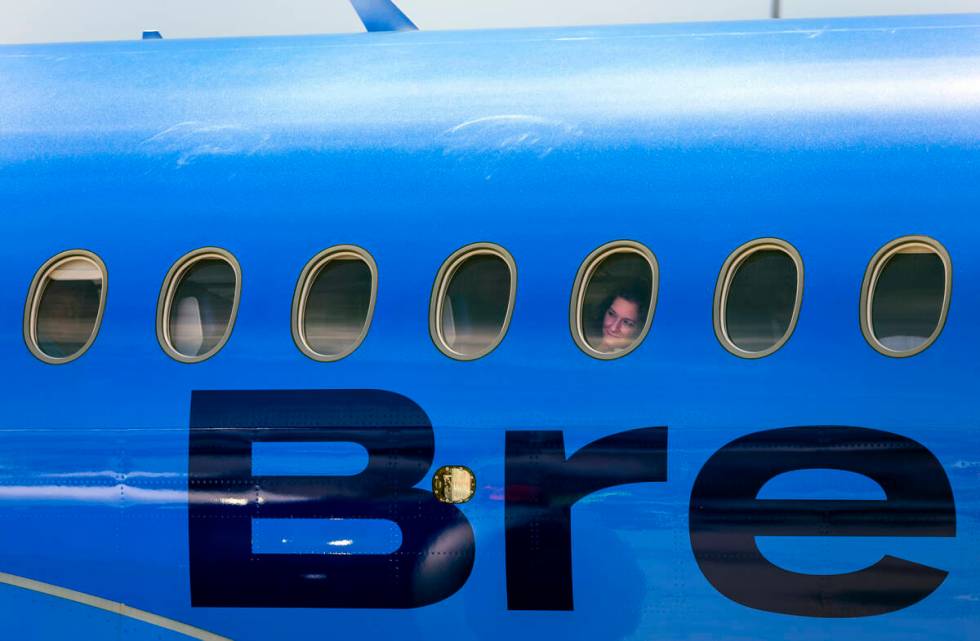 A Breeze Airways passenger looks out the window as their inaugural flight arrival makes it to t ...