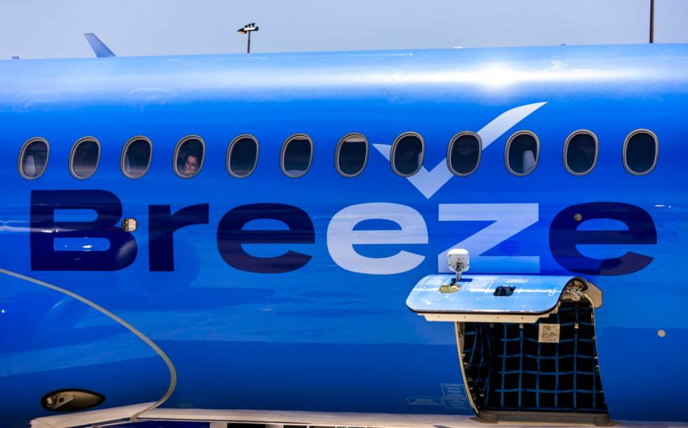 A Breeze Airways passenger looks out the window as their inaugural flight arrival makes it to t ...