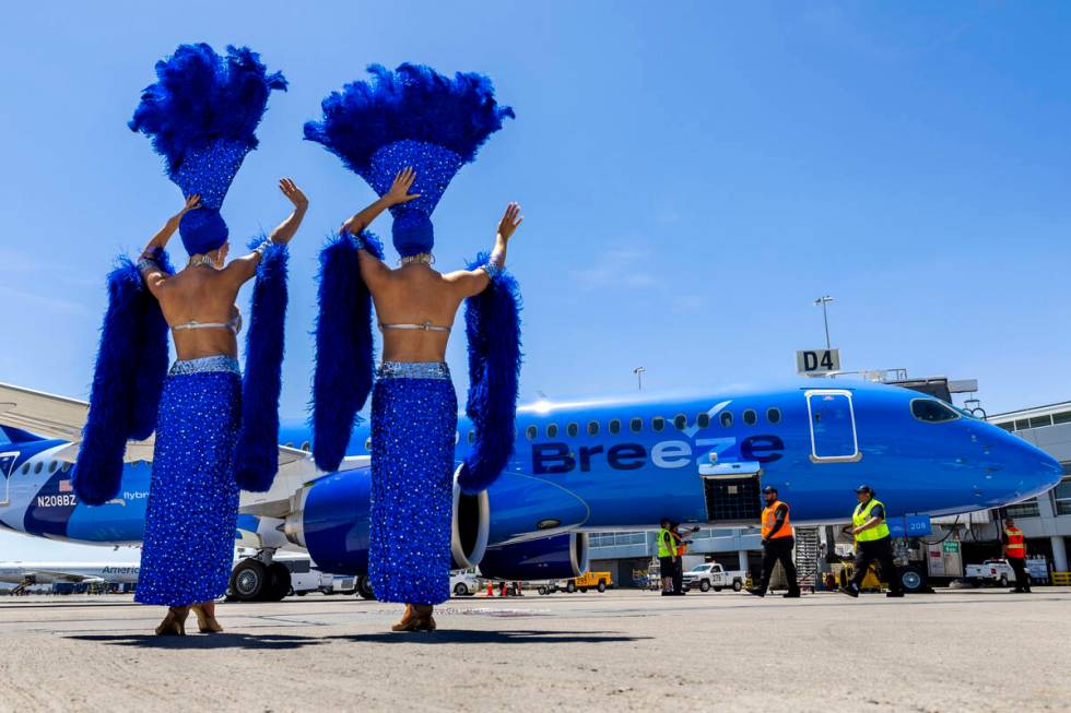 Showgirls Brooke, left, and Tara welcome passengers for the Breeze Airways inaugural flight arr ...