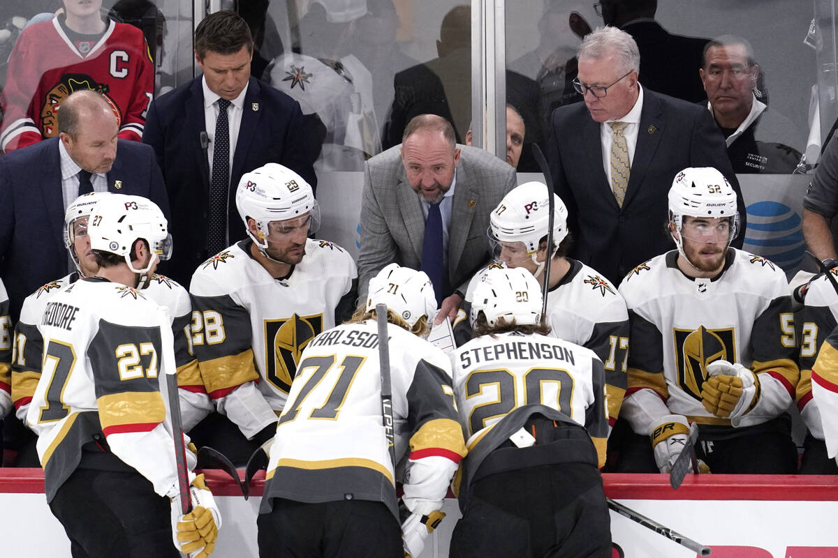 Vegas Golden Knights head coach Peter DeBoer, center, talks to players during the third period ...