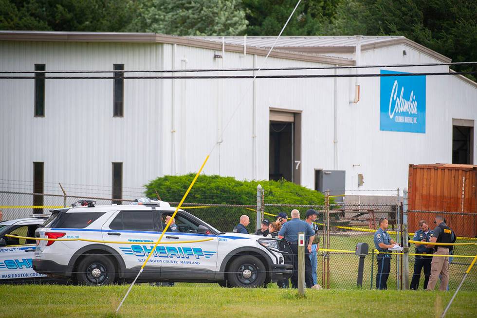 Law enforcement officials stand near the scene of a shooting at Columbia Machine, Inc., in Smit ...