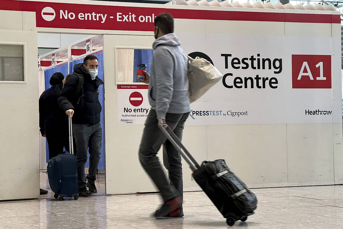 Passengers get a COVID-19 test at Heathrow Airport in London, Nov. 29, 2021. The Biden adminis ...