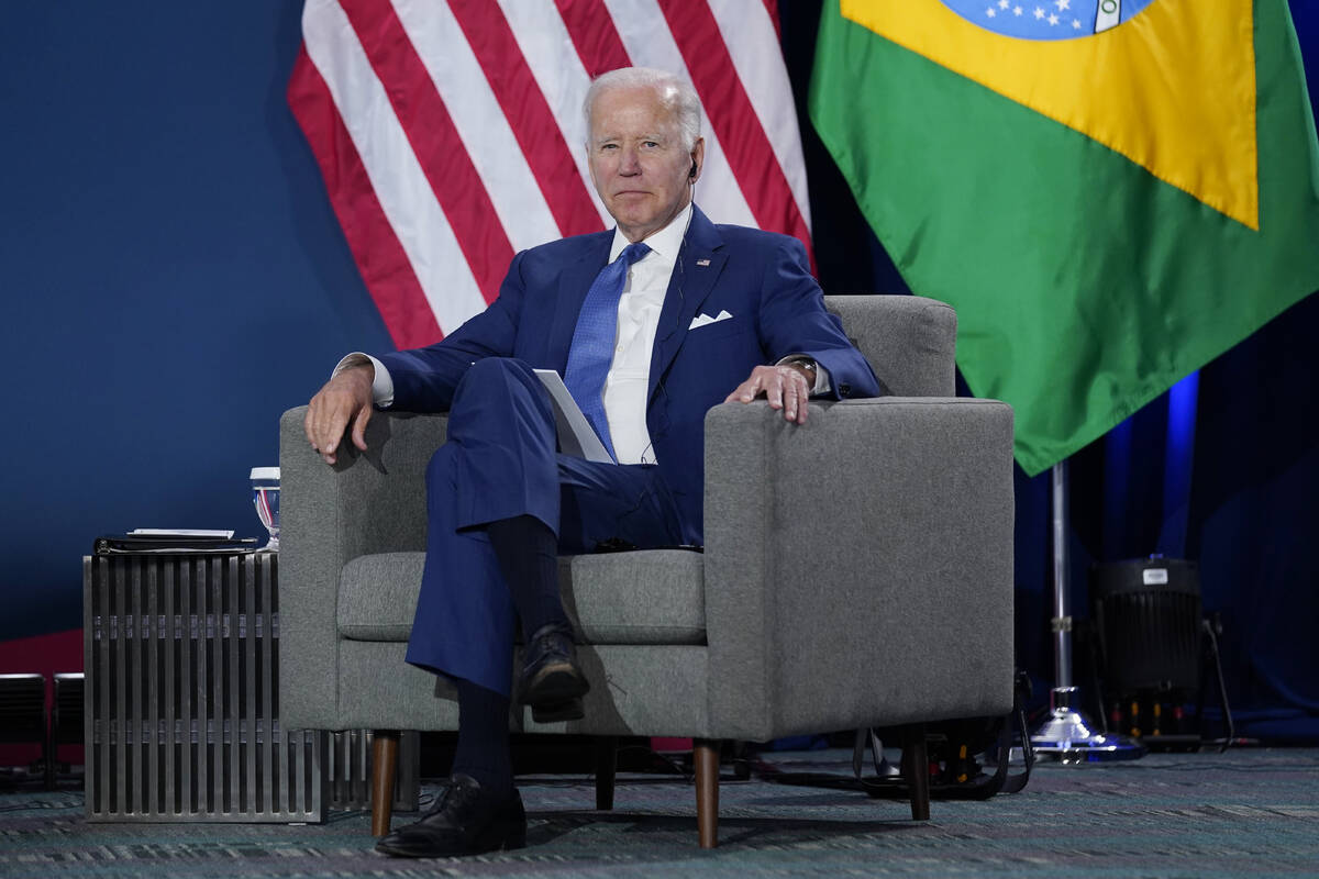 President Joe Biden listens at a meeting with Brazilian President Jair Bolsonaro during the Sum ...
