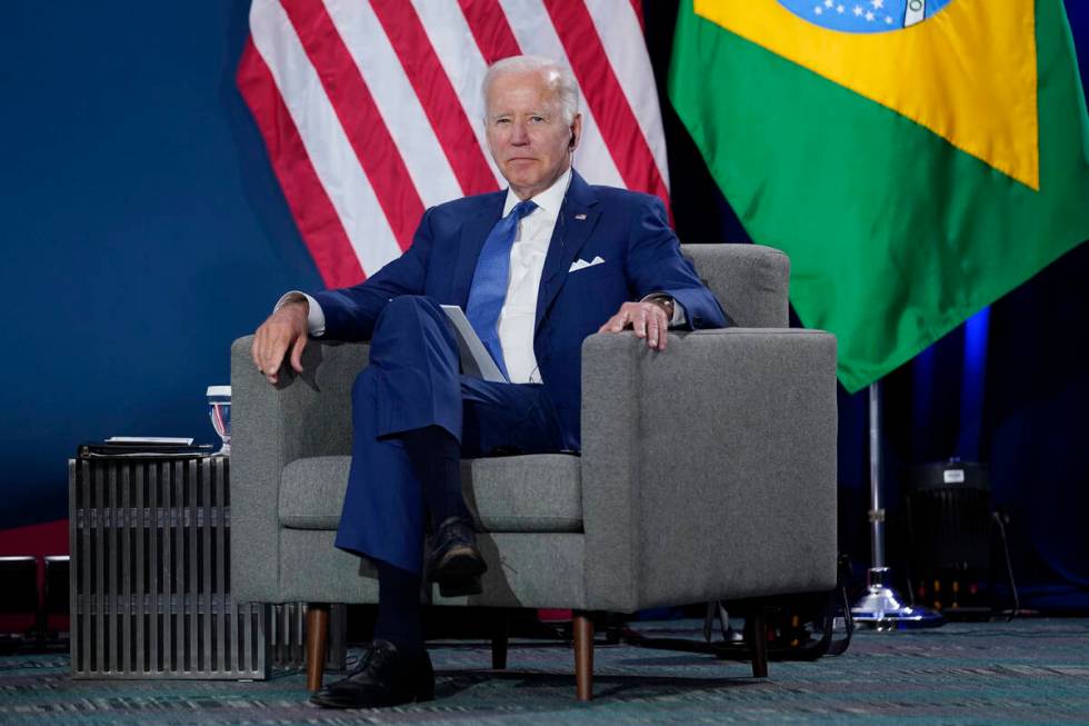 President Joe Biden listens at a meeting with Brazilian President Jair Bolsonaro during the Sum ...